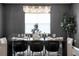 Formal dining room featuring a dark wood table and chandelier at 4360 Sunset Preserve Blvd, Orlando, FL 32820