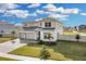 Two-story house with solar panels, three-car garage, and landscaped yard at 4360 Sunset Preserve Blvd, Orlando, FL 32820