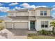 Two-story house with solar panels, three-car garage, and landscaped yard at 4360 Sunset Preserve Blvd, Orlando, FL 32820