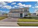 Two-story house with solar panels, three-car garage, and landscaped yard at 4360 Sunset Preserve Blvd, Orlando, FL 32820
