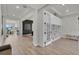 Bright foyer with hardwood floors, built-in shelving, and access to other rooms at 4360 Sunset Preserve Blvd, Orlando, FL 32820