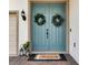 Double front doors with wreaths and a welcome mat at 4360 Sunset Preserve Blvd, Orlando, FL 32820