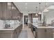 Modern kitchen with island, stainless steel appliances, and white countertops at 4360 Sunset Preserve Blvd, Orlando, FL 32820