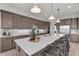 Eat-in kitchen with a long island, white countertops, and dark cabinetry at 4360 Sunset Preserve Blvd, Orlando, FL 32820