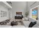 Open living space with sectional sofa and large windows overlooking backyard at 4360 Sunset Preserve Blvd, Orlando, FL 32820