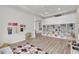 Large playroom with built-in shelving and a cozy corner at 4360 Sunset Preserve Blvd, Orlando, FL 32820