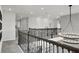 Open second floor hallway with chandelier and railing at 4360 Sunset Preserve Blvd, Orlando, FL 32820
