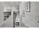 Upstairs hallway with carpet and wrought iron railing at 4360 Sunset Preserve Blvd, Orlando, FL 32820