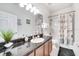 Clean bathroom with a shower/tub combo and dark vanity at 4973 Pall Mall W St, Kissimmee, FL 34758