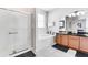 Elegant bathroom with a soaking tub, walk-in shower, and dark wood cabinets at 4973 Pall Mall W St, Kissimmee, FL 34758