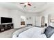 Bright bedroom with a comfy bed, ensuite bathroom access, and a wall-mounted TV at 4973 Pall Mall W St, Kissimmee, FL 34758