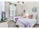 Bright bedroom with twin beds, TV, and window at 4973 Pall Mall W St, Kissimmee, FL 34758