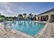 Community pool with lounge chairs and a water feature at 4973 Pall Mall W St, Kissimmee, FL 34758