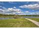 Scenic lake view with a wooden footbridge at 4973 Pall Mall W St, Kissimmee, FL 34758