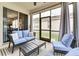 Relaxing lanai with wicker furniture and curtains at 4973 Pall Mall W St, Kissimmee, FL 34758