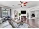 Spacious living room with hardwood floors, sectional sofa, and large TV at 4973 Pall Mall W St, Kissimmee, FL 34758