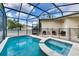 Screened pool and spa with comfortable seating area at 4973 Pall Mall W St, Kissimmee, FL 34758