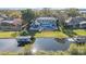 Aerial view of a stunning waterfront property with pool, patio, and boat dock on a serene waterway at 6025 Lady Bet Dr, Orlando, FL 32819