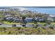 Aerial view of a waterfront estate featuring a pool, boat docks, and lush landscaping at 6025 Lady Bet Dr, Orlando, FL 32819