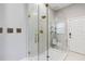 The bathroom is updated with a glass shower enclosure and neutral tiling at 6025 Lady Bet Dr, Orlando, FL 32819