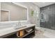 Bathroom featuring a large, modern backlit mirror, sleek vanity, and a glass-enclosed shower with stylish tiling at 6025 Lady Bet Dr, Orlando, FL 32819