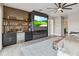 Luxurious bedroom with a built-in bar, fireplace, and large TV at 6025 Lady Bet Dr, Orlando, FL 32819