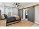 This bedroom features an elegant ceiling fan and sliding barn doors leading into the ensuite bathroom at 6025 Lady Bet Dr, Orlando, FL 32819