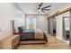 Bright bedroom with barn door, ceiling fan, and large window at 6025 Lady Bet Dr, Orlando, FL 32819