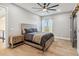 This bedroom features hard wood floors, a ceiling fan and a large window at 6025 Lady Bet Dr, Orlando, FL 32819