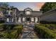 Elegant home featuring a covered front porch with stately columns and professionally landscaped yard at 6025 Lady Bet Dr, Orlando, FL 32819