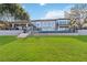 Beautiful home with manicured lawn, outdoor entertaining space, and elegant architecture at 6025 Lady Bet Dr, Orlando, FL 32819