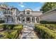 Beautiful front entrance with stately columns and a manicured walkway at 6025 Lady Bet Dr, Orlando, FL 32819