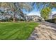 Elegant home with a manicured lawn and a circular driveway at 6025 Lady Bet Dr, Orlando, FL 32819