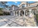 Spacious front patio with decorative columns and a basketball hoop at 6025 Lady Bet Dr, Orlando, FL 32819