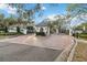Elegant gated community entrance with meticulous landscaping and a secure entry at 6025 Lady Bet Dr, Orlando, FL 32819