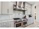 Contemporary kitchen with premium range and sleek stainless steel hood vent at 6025 Lady Bet Dr, Orlando, FL 32819