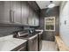 Modern laundry room with dark cabinetry, quartz countertops, and LG washer and dryer at 6025 Lady Bet Dr, Orlando, FL 32819