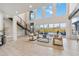 Bright living room featuring floor-to-ceiling windows and modern staircase at 6025 Lady Bet Dr, Orlando, FL 32819