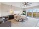 This main bedroom features elegant light fixtures, a seating area, and access to a private balcony at 6025 Lady Bet Dr, Orlando, FL 32819