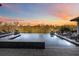 Stunning infinity pool with waterfront views and lounge chairs, perfect for relaxation and entertaining at 6025 Lady Bet Dr, Orlando, FL 32819