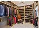 Spacious walk-in closet featuring custom shelving, ample storage, and marble flooring at 6025 Lady Bet Dr, Orlando, FL 32819