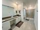 Elegant bathroom with double vanity and walk-in shower at 8900 Takeaway Way, Davenport, FL 33896