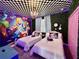 Alice in Wonderland themed bedroom with two twin beds, mural, and whimsical decor at 8900 Takeaway Way, Davenport, FL 33896