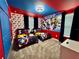 Superhero themed bedroom with twin beds and mural at 8900 Takeaway Way, Davenport, FL 33896