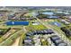 Aerial view of community with golf course, lakes, and homes at 8900 Takeaway Way, Davenport, FL 33896