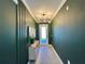 Modern entryway with dark green walls and wood accent at 8900 Takeaway Way, Davenport, FL 33896