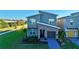 Modern two-story home with gray siding and stone accents at 8900 Takeaway Way, Davenport, FL 33896