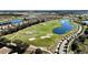 Aerial view of community golf course with lakes and homes at 8900 Takeaway Way, Davenport, FL 33896