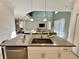 Open kitchen island overlooking living room, features modern fixtures at 8900 Takeaway Way, Davenport, FL 33896