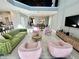 Bright and airy living room with green sofa and pink chairs at 8900 Takeaway Way, Davenport, FL 33896